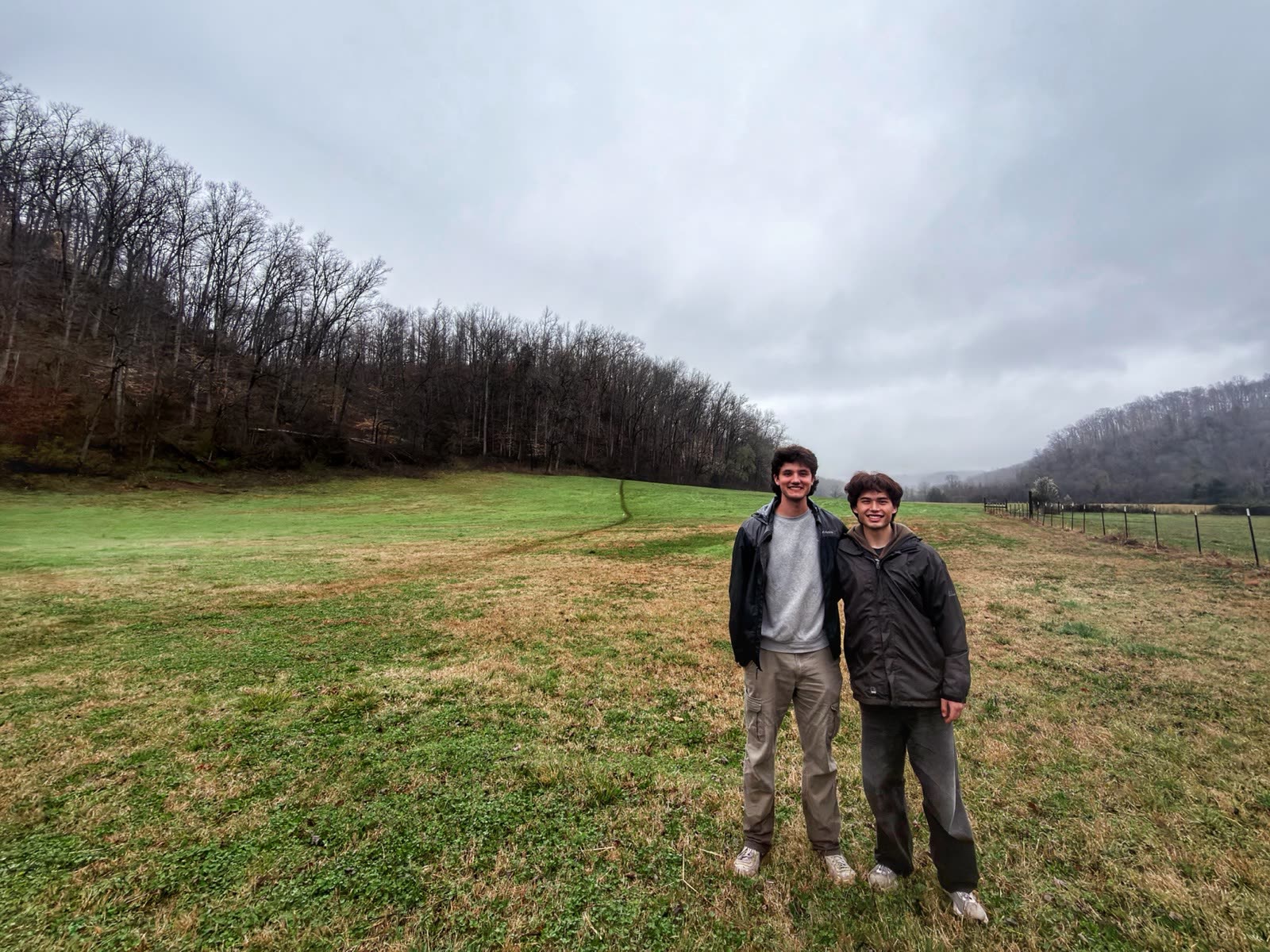 Raphael Dael and a crew member standing in the misty field between setups.