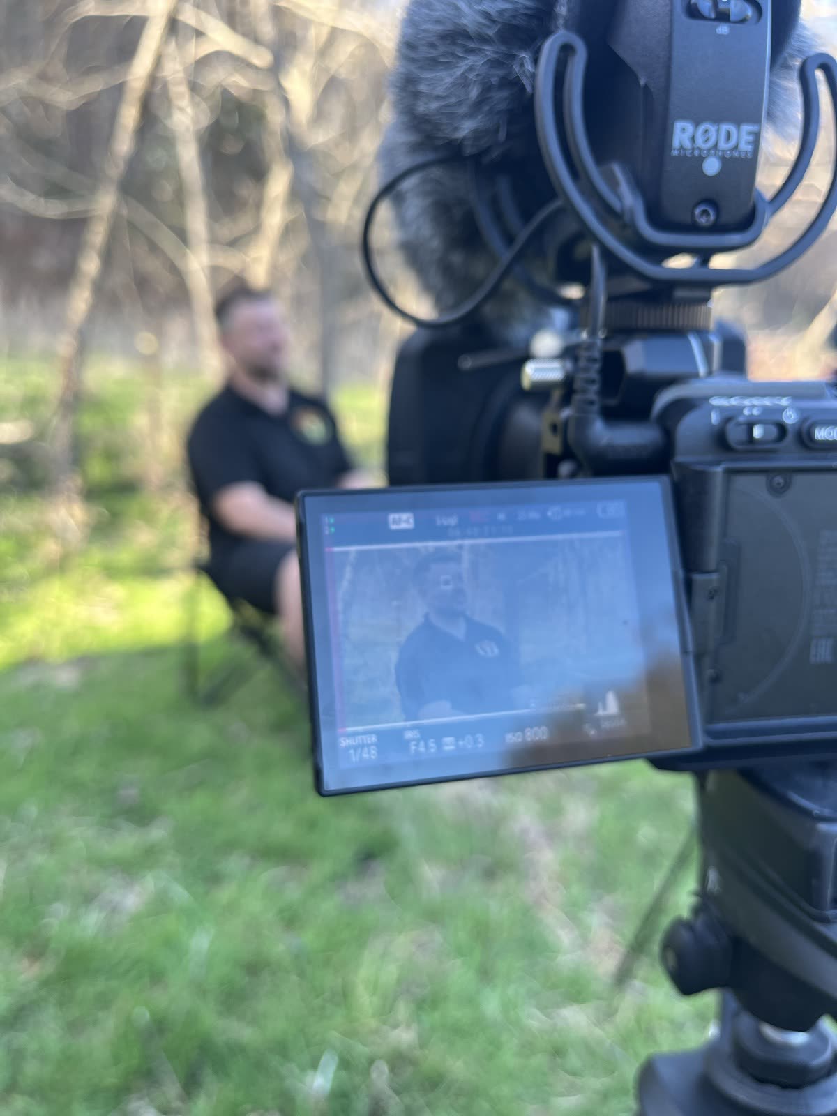 Checking the frame on the camera monitor during an interview.