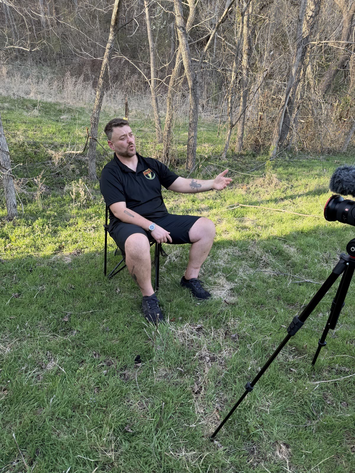 An interview subject talks through the race from a camp chair by the treeline.