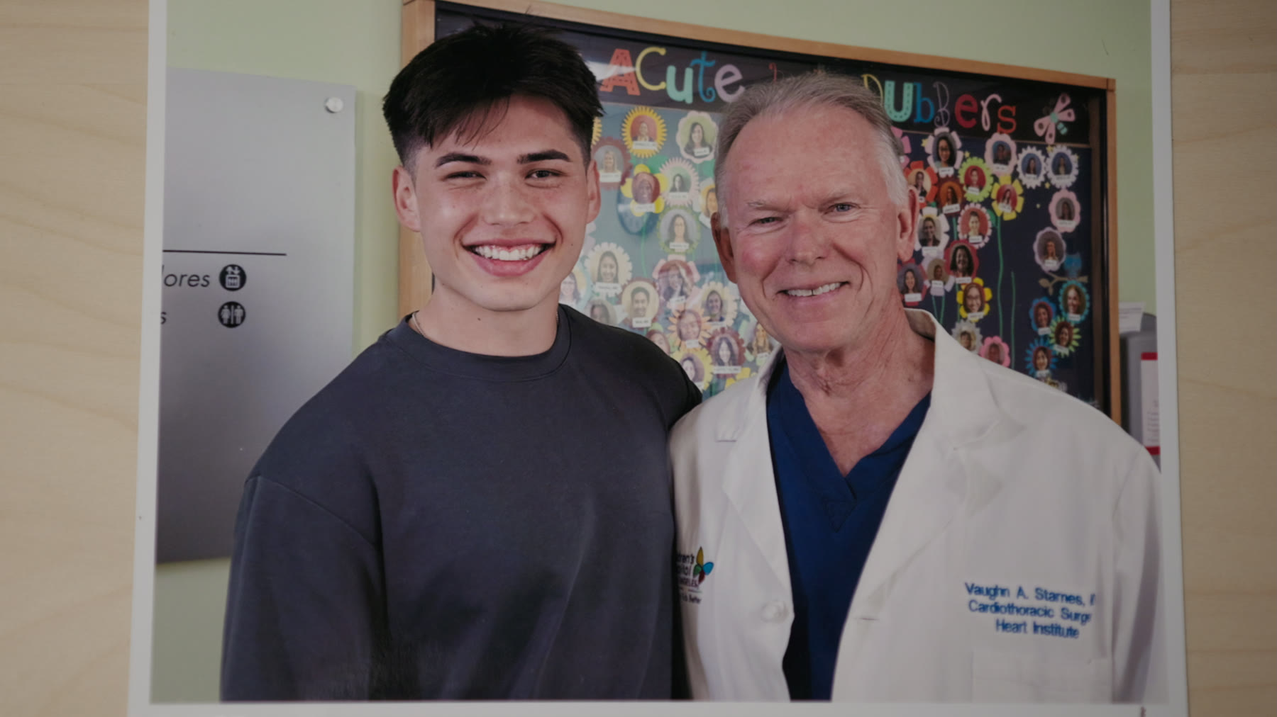 Christopher Dael, now grown, stands smiling beside Dr. Vaughn Starnes at Children's Hospital Los Angeles.